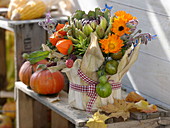 Thanksgiving - arrangement stuck in yoghurt pail with corn leaves