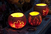 Luminous pumpkins carved with leaf decoration