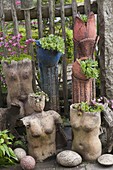 Artist's garden: potted art objects on the fence