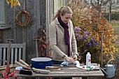 Woman cleaning and oiling garden tools