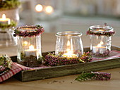 Canning jars as lanterns, decorated with small wreaths of calluna