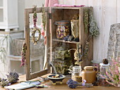 Small cupboard with dried herbs and incense bundles