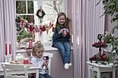 Girl with Advent calendar at the window