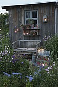 Garden house in the evening lighting with lanterns and lanterns