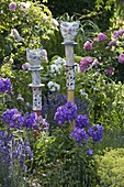 Potted cats as decorative pins on wooden posts, phlox