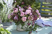 Bouquet of roses in metal jardiniere: Pink 'Lovely Jewel' Micca Sensation