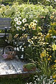 White-yellow terrace bed on wooden deck