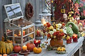 Autumnal light arrangement with pumpkins (Cucurbita), bouquet