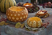 Decorative carved pumpkin (Cucurbita) in a wreath of twigs