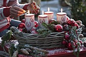 Advent basket with red balls, candles with deer decoration