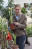 Woman buying flowers at garden centre