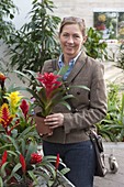 Woman buying flowers at garden centre