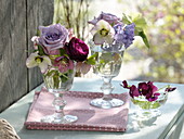 Small bouquets in wine glasses: Rosa (roses), Helleborus orientalis
