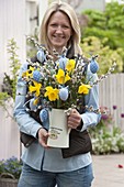 Woman with an Easter bouquet in enamelled jug, Narcissus (Daffodil)