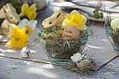 Small glass bowl as Easter nest with hay