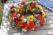 Wreath of edible flowers and herbs, marigolds (calendula)