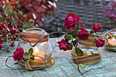 Autumn lantern with red flowers of pink (rose), leaves