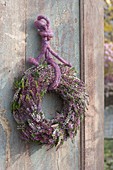 Wreath of Calluna vulgaris (Flowering broom heather) on an old wooden gate