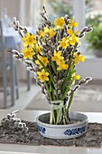 Standing bouquet of Narcissus 'Tete a Tete' (daffodils) and Salix