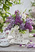 Fragrant bouquet of Syringa (Lilac) in grandma's old coffee pot