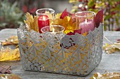 Lace basket with glasses and autumn leaves as a lantern