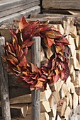 Wreath made of leaves of Prunus (ornamental cherry) at the firewood storehouse