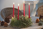 Viennese Advent wreath made of metal frame with pine needles and red candles