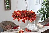 Physalis wreath with fairy lights as a hanging table decoration