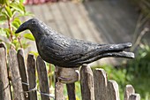 Handmade ceramic crow as fence stool