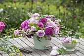 Fragrance bouquet of rose and Valeriana in a tin bucket