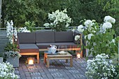 Terrace with white plants, lounge corner and table, Hydrangea 'Annabelle'