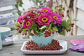 Autumn bouquet on terrace table, Zinnia (Zinnia), branches