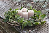 Advent wreath made from Hedera, and clematis tendrils with beige candles
