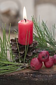 Candle on pine cones