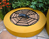 RAISED CHILDRENS SANDPIT PAINTED MUSTARD Yellow with Metal SPIDERS WEB GRID OVER THE TOP. Mercedes - Benz Garden, TATTON Park 2002. DESIGNED by JANE MOONEY