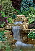 WATERFALL IN Garden DESIGNED by BRIAN AUGHTON AND TERESSA POTTER, TATTON Park 2002. PLANTS by TARLETON SPECIMEN PLANTS