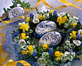 Plate wreath with flowers of daffodils, daisies, grape hyacinths and leaves from Box and Hedge maids
