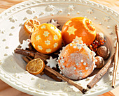 Oranges decorated for Christmas with pearl pins.