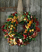 Door wreath of Acer (maple leaves), Buxus (boxwood), Malus (ornamental apples)