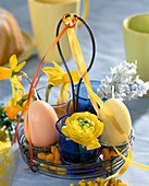 Wire frame with candle eggs, daffodils, ranunculus