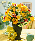 Bouquet of tulips, daffodils, ivy leaves and ornamental asparagus branches