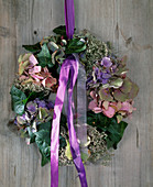 Door wreath of Hydrangea macrophylla (hydrangea), Hedera (ivy), Limonium (beach lilac)