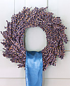 Door wreath of Lavandula angustifolia (lavender) on straw wreath
