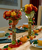 Table decoration: Glasses with Dendranthema (autumn chrysanthemum), Sorbus (rowan berries)