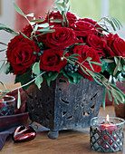 Iron pot with red roses, olive branches, Hedera (ivy with berries)