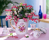 Milk jug with Dicentra (Weeping Heart) with white and pink flowers