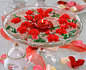 Rose blossoms in a glass bowl with a floating rose candle