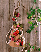 Bag made of old hop sack with rose petals made of silk fabric