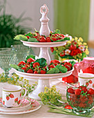 Porcelain etagere with strawberries, Alchemilla (lady's mantle)