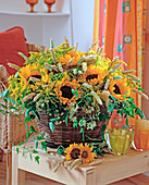 Basket with Helianthus annuus (sunflower), clematis tendrils